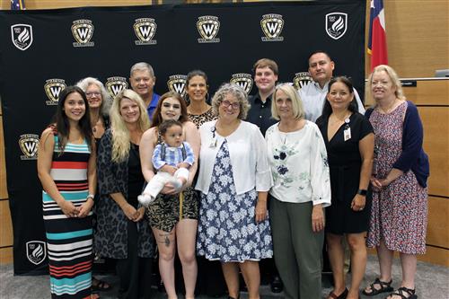 Graduate surrounded by teachers